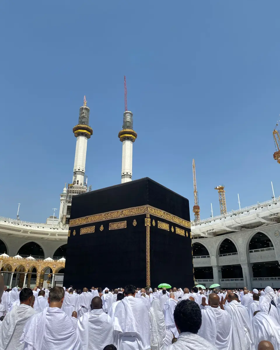 Kâbe önünde dua eden beyaz giysili hacılar